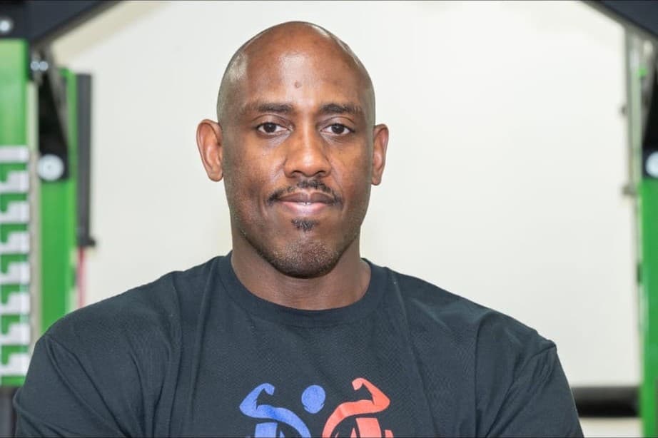 Coach Len smiling in a Fitness Gs shirt